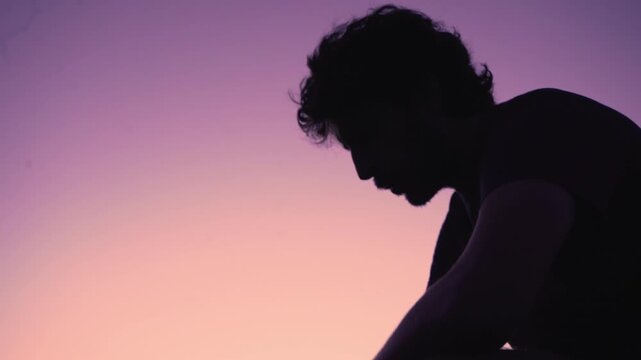 Man in Silhouette Contemplating Nature at Golden Hour Sunset