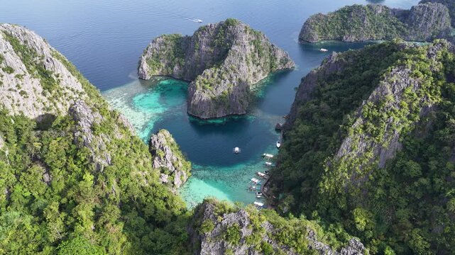 Cinematic aerial video of tropical islands of Coron in the Philippines with limestone cliffs and azure blue water lagoons