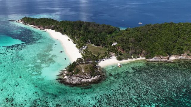 Cinematic aerial video of tropical island in the Philippines with palm trees and beautiful beach