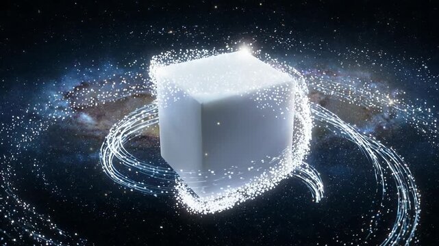 A glowing white cube sits in the center of deep space as luminous particles and energy trails rotate around it in a swirling motion against a galaxy background