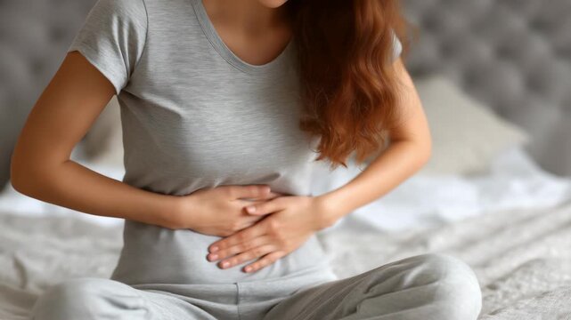  Caucasian woman holding her stomach and  rub it. Concept of abdominal discomfort, digestion problem, stress relief, 