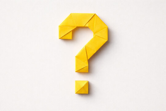Bright yellow origami question mark on a plain light gray matte background, crafted from solid yellow paper with precise sharp folds forming a classic stylized  '?'  shape, including the curved hook.