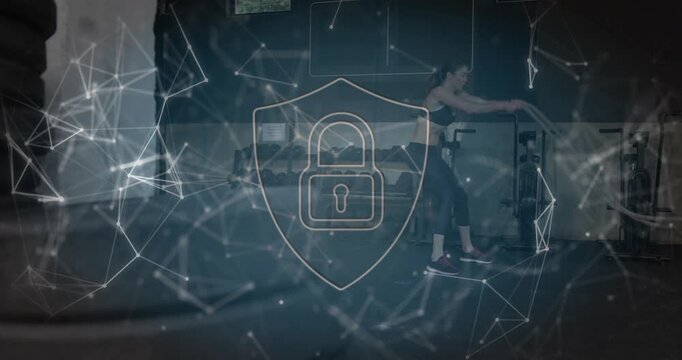 Woman gripping battle ropes, making waves and slams for fitness shield overlay partly hiding view