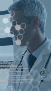 Vertical video: HUD appearing, doctor standing by window turning head and smiling to review data