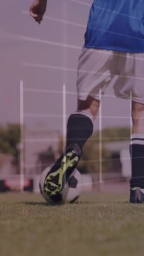 Vertical video: Female soccer player tapping ball, dribbling toward goal on grass with metric lines