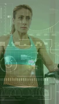 Vertical video: Rowing woman in sports bra starting strokes on rower for workout at gym HUD overlay