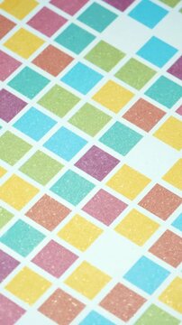 Vertical Panning Over Multi Colored Square Grid Pattern with Shimmering Glitter Texture, Close Up Movement of Colorful Mosaic Geometric Squares on Sparkling White Surface
