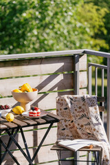 Fototapeta premium Balcony scene with breakfast table and fruit in a cozy apartment setting