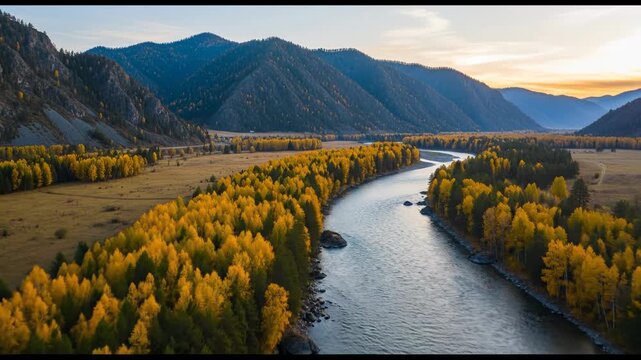 A serene river winds through a valley with trees displaying vibrant yellow foliage, surrounded by mountains