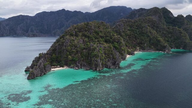 Cinematic drone video of tropical islands of Coron in the Philippines,  with azure blue water and lime stone rock formations