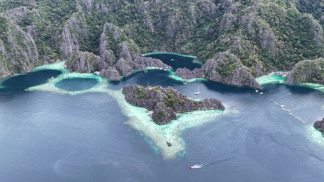 Cinematic drone video of tropical islands of Coron in the Philippines,  with azure blue water and lime stone rock formations
