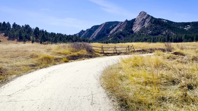 POV Hike on Chautauqua Trail Toward the Flatirons, Boulder, Colorado - First Person Walking Shot, Golden Grasslands, Rocky Mountains, Clear Blue Sky
