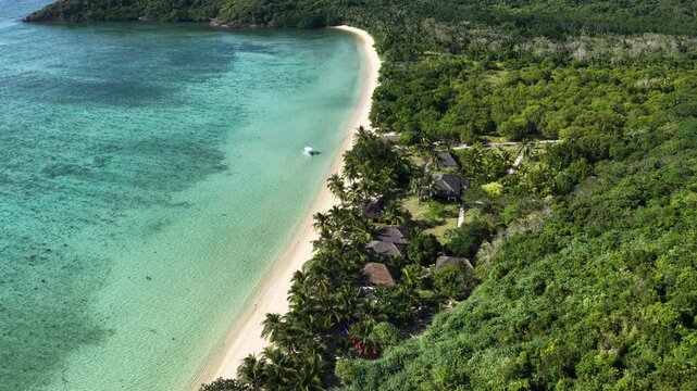 Cinematic drone video of tropical island with perfect sand beach in the Philippines  with azure blue water and beach