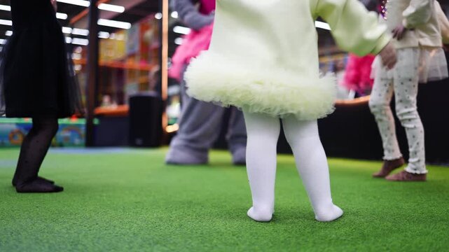 Children Having Fun in entertainment center. Joyful Kids are Dancing with Their Daycare Pedagogue, Boys and Girls Having a Party at Daycare Preschool.