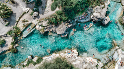 Obraz premium Aerial view of people swimming in natural rock pools