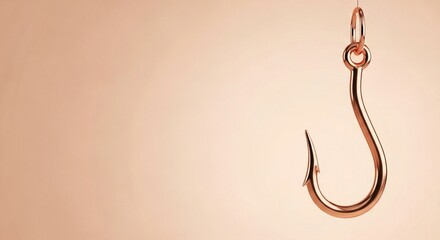 A shiny copper fishing hook hangs from a line against a soft peach background