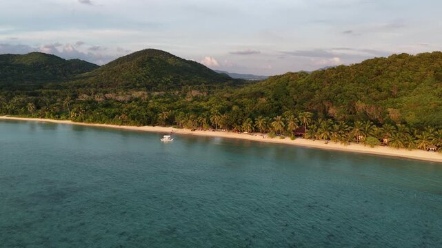Cinematic drone video of tropical island in the Philippines  with azure blue water and beach