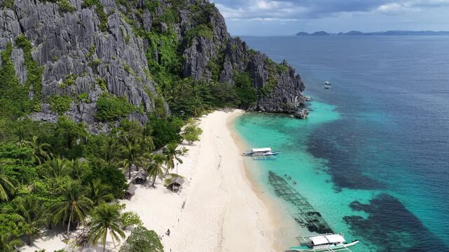Cinematic drone video of tropical island in the Philippines  with azure blue water and beach