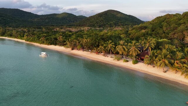 Cinematic drone video of tropical island in the Philippines  with azure blue water and beach
