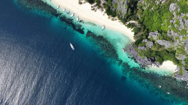 Cinematic drone video of tropical island in the Philippines  with azure blue water and beach