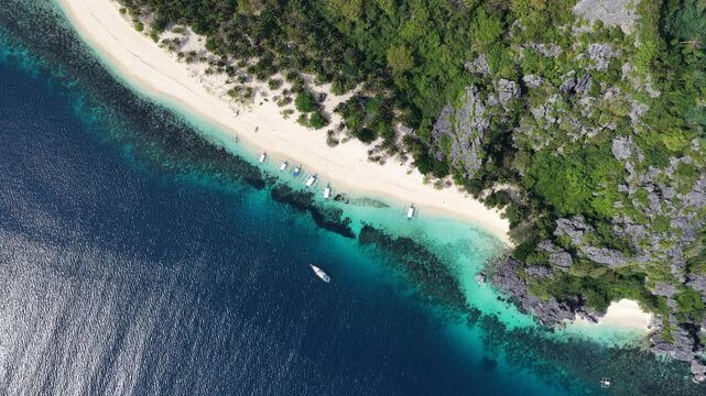 Cinematic drone video of tropical island in the Philippines  with azure blue water and beach