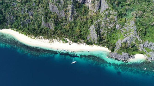 Cinematic drone video of tropical island in the Philippines  with azure blue water and beach