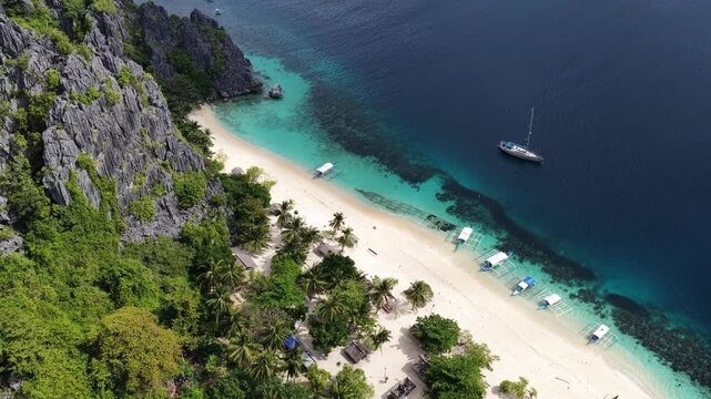 Cinematic drone video of tropical island in the Philippines  with azure blue water and beach