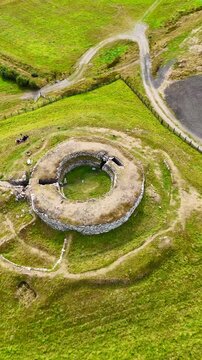 Aerial View of Carn Liath Broch, a Prehistoric Iron Age Stone Fortress in the Scottish Highlands, Ancient Archaeological Heritage Site in Sutherland, Scotland