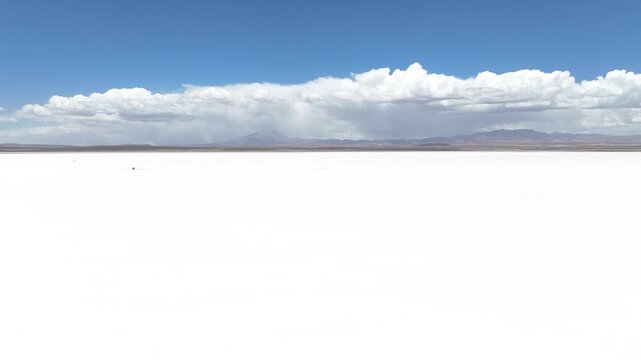 Salar de Uyuni. Endless white landscape and rider on the vast Bolivian salt flats.