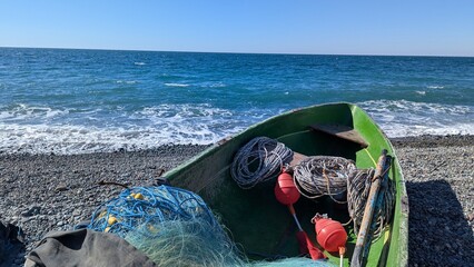 Fishing Nets and Buoys Inside Small Boat on Black Sea Beach in Kobuleti Georgia © Anton