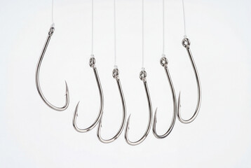 Silver fishing hooks arranged in curve on suspended lines