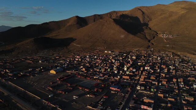 Dramatic sunset over the Altiplano in Huachacalla, Bolivia. Burning orange sky over the high plateau and rural landscape.