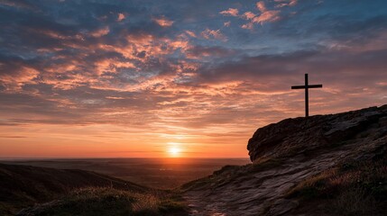 A serene landscape of a cross on a hill at sunset with a vibrant sky