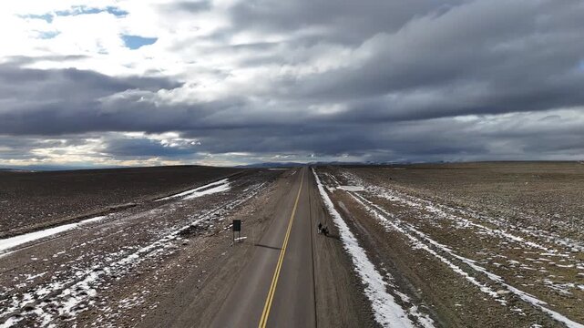 Man riding adventure motorcycle on the iconic Route 40 (Ruta 40) in Santa Cruz. Endless highway through the Patagonian steppe.