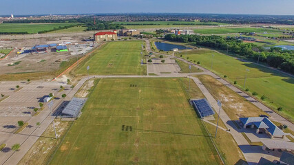 Naklejka premium Aerial Drone photo of McKinney Soccer Complex at Craig Ranch at sunset
