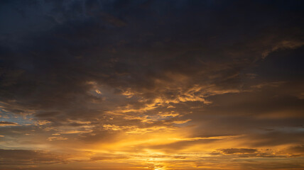 Fototapeta premium Amazing sunset skyscape. Evening sky with bright colorful orange and yellow clouds
