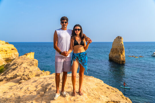 Couple enjoying summer holidays in algarve, portugal, near praia da marinha