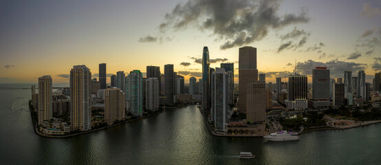 Naklejka premium View from above of high skyscraper buildings in downtown district of Miami Brickell in Florida, USA at sunset. American megapolis with business financial district at nightfall