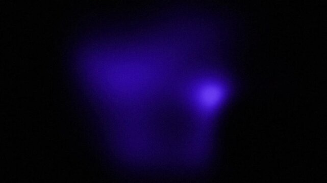 Abstract black and blue light speckled grain background, bright color gradient shape with soft texture