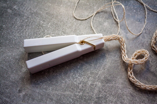Weight clip for knitting spool cord making