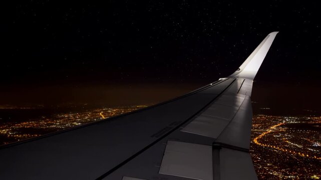 Skyline From Above. Cruising At Altitude Reveals Bustling City Streets Glowing Under Starry Night Sky