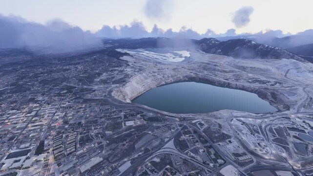 Side aerial drone view at sunrise of Berkeley Pit Mine in Butte. Montana. United States