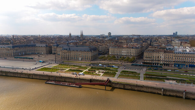 Aerial view of Place de la Bourse and the Garonne River in Bordeaux France, showing historic buildings and urban landscape 
