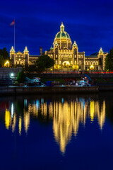 Fototapeta premium Victoria Parliament Building Inner Harbour Reflection. Victoria's Inner Harbor and marina in downtown Victoria. The historic Legislative Building at night looks over the harbor. British Columbia. 