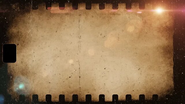Vintage film reel with dust and light leaks, old cinema background.