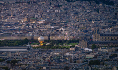 Aerial view of Tuileries Garden in Paris, France, with Paris 2024 Olympic golden balloon of the olympic flame and Tuileries Ferris wheel. The cauldron, debuted during the 2024 Summer Olympic Games © Vadim Rodnev