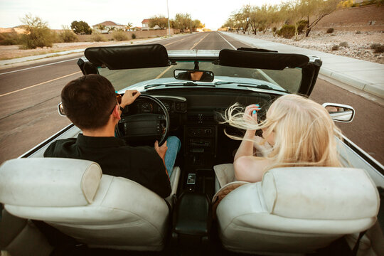 Couple driving in classic convertible