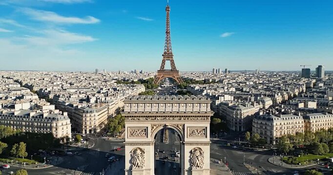 Arc de Triomphe and Eiffel Tower in Paris cityscape on sunny day