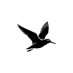 Obraz premium Graceful black silhouette of a bird in mid-flight with outstretched wings