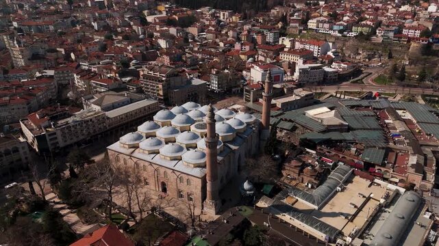 Aerial drone view of the historic Grand Mosque (Ulu Camii) and old city center of Bursa, Turkey.